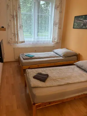 three beds in a room with a window at Apartmány Topolová 909B in Milovice