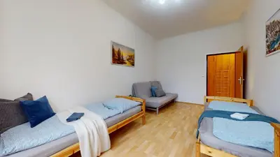 a living room with two beds and a couch at Apartmány Topolová 909B in Milovice