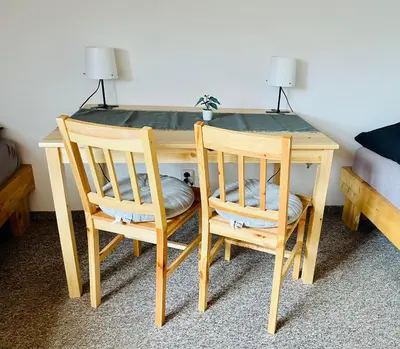 a room with a bed with a towel and a table at Hvězdonice Hostinec U Kuželků in Hvězdonice