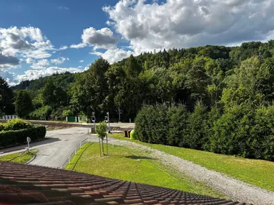 a road with a tree in the middle of a street at Hvězdonice Hostinec U Kuželků in Hvězdonice