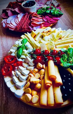 a plate of cheese and vegetables on a wooden table at Hvězdonice Hostinec U Kuželků in Hvězdonice