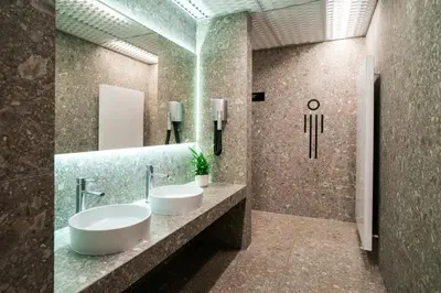 a bathroom with two sinks and a mirror at Hotel & Spa Chariclea in Poděbrady