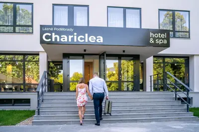 a man and woman walking up the stairs of a hotel at Hotel & Spa Chariclea in Poděbrady