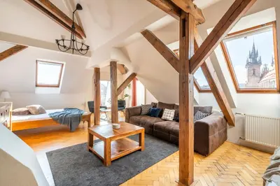 a living room with a couch and a table at Štupartská - Tyn Church View Residence with terrace in Prague