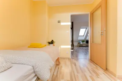 a bedroom with two beds and a hallway at Jane's Charming Apartment in Prague