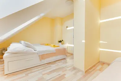 a bedroom with a white bed and a staircase at Jane's Charming Apartment in Prague