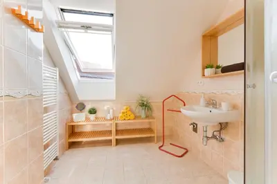 a bathroom with a sink and a skylight at Jane's Charming Apartment in Prague