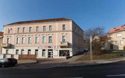 a large pink building on the corner of a street at Jane's Charming Apartment in Prague