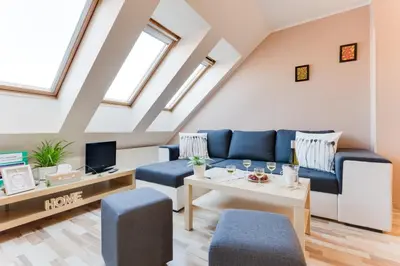 a living room with a couch and a table at Jane's Charming Apartment in Prague