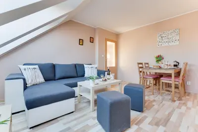 a living room with a blue couch and a table at Jane's Charming Apartment in Prague