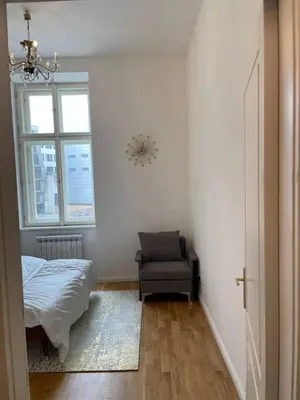 a bedroom with a bed and a chair and a window at 2-Bed Apartment in Praha in Hřebečníky