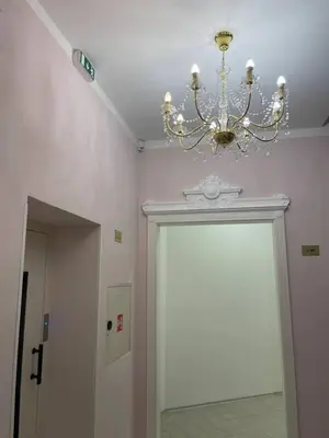 a chandelier is hanging over a door in a room at 2-Bed Apartment in Praha in Hřebečníky