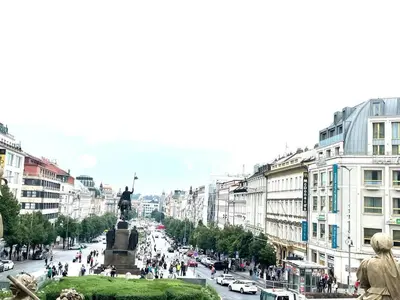 a city with a statue in the middle of a street at 2-Bed Apartment in Praha in Hřebečníky
