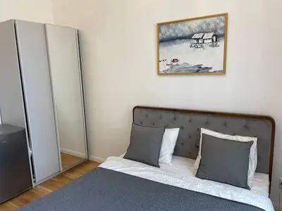 a bedroom with a bed and a picture on the wall at 2-Bed Apartment in Praha in Hřebečníky
