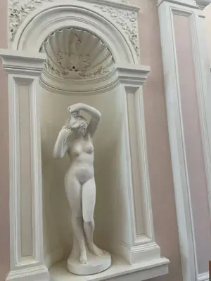 a statue of a woman standing on a wall at 2-Bed Apartment in Praha in Hřebečníky