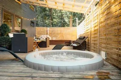a hot tub in the middle of a patio at Secret Lake Prag magic place relaxation& wellness in Řehenice