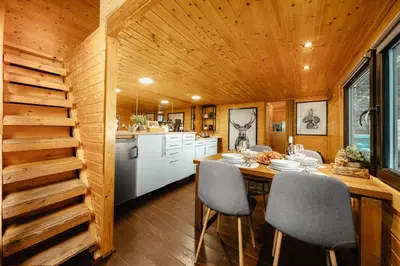 a kitchen and dining room with a table and chairs at Secret Lake Prag magic place relaxation& wellness in Řehenice