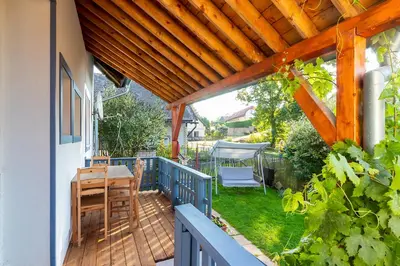 a patio with a table and chairs on a deck at Oplanská chalupa in Oplany