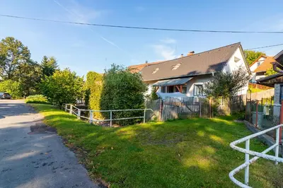 a house with a fence on the side of the road at Oplanská chalupa in Oplany