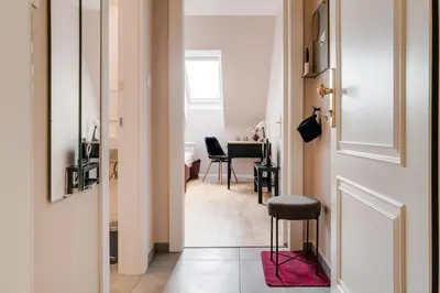 a hallway with a door and a table with chairs at Cosy apartment right after the National Museum in Prague