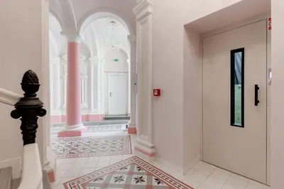a hallway with a door and a tile floor at Cosy apartment right after the National Museum in Prague
