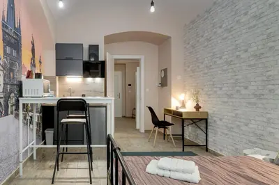 a kitchen and living room with a table and chairs at Cosy apartment right after the National Museum in Prague