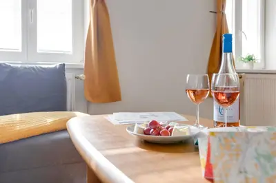 a dining room with a table and chairs in a room at Sunshine Apartment near the City center in Prague