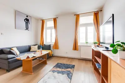 a living room with a bed and a couch at Sunshine Apartment near the City center in Prague