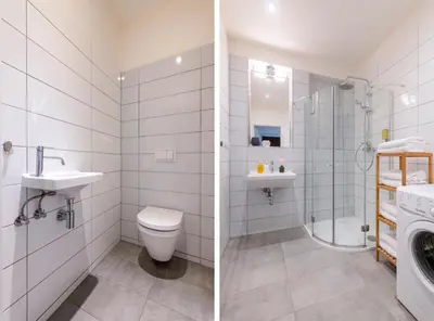 a bathroom with a toilet sink and a washing machine at Prague Tales Boutique Residence by Dwellfort in Prague