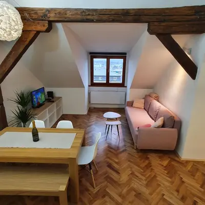 a living room with a couch and a table at Prague Castle View Apartment in Prague