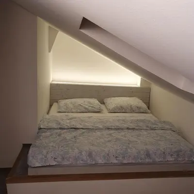 a bed with two pillows on it in a room at Prague Castle View Apartment in Prague