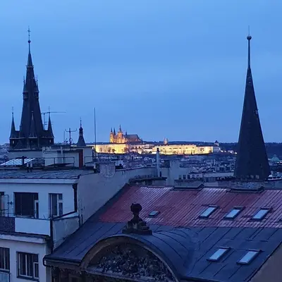 a view of a city at night with a building at Prague Castle View Apartment in Prague