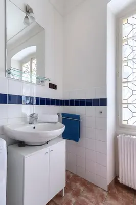 a white bathroom with a sink and a mirror at Historic Spirit at Studio under the Prague Castle in Prague