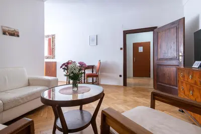 a living room with a vase of flowers on a table at Historic Spirit at Studio under the Prague Castle in Prague