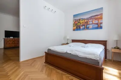 a bedroom with a bed and a painting on the wall at Historic Spirit at Studio under the Prague Castle in Prague