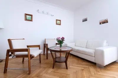 a living room with a white couch and a table at Historic Spirit at Studio under the Prague Castle in Prague