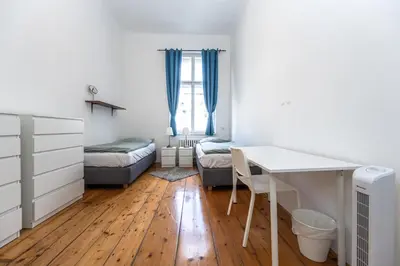 a bedroom with a desk and a bed and a table at Apartments Safarikova 18 in Prague