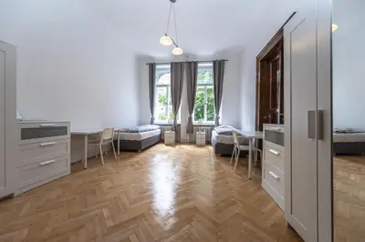 a room with a kitchen and a dining room at Apartments Safarikova 18 in Prague