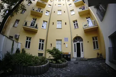 a yellow building with balconies on the side of it at 420Welcome.Inn in Prague