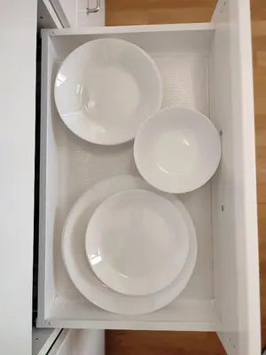 three white plates in a white cabinet at 420Welcome.Inn in Prague