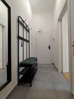 a hallway with a black bench in front of a door at 420Welcome.Inn in Prague
