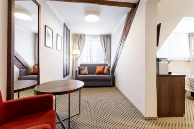 a living room with a table and a couch at Hotel Ikona in Prague