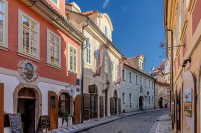 an empty street in an old town with buildings at Hotel Ikona in Prague