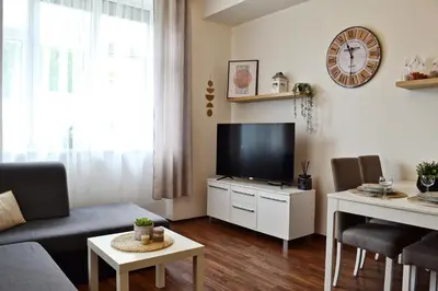 a living room with a tv on a white cabinet at Apartmán u Fontány in Poděbrady