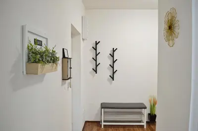 a room with a bench and plants on the wall at Apartmán u Fontány in Poděbrady
