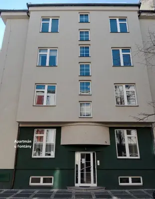an apartment building on the corner of a street at Apartmán u Fontány in Poděbrady