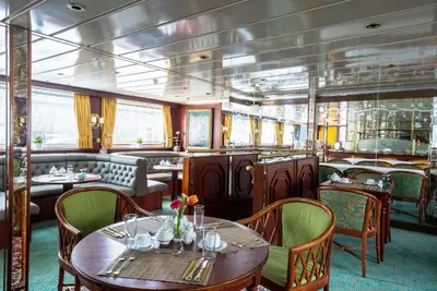 a restaurant on a cruise ship with tables and chairs at River hotel KÖNIGSTEIN in Prague