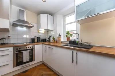 a dining room with a wooden table and chairs at Charles Apartments in Old Town in Prague