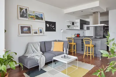 a living room with a couch and a kitchen at Prague Days - One-bedroom Apartment with Balcony and Garage Parking near the Vltava River in Holešovice in Prague