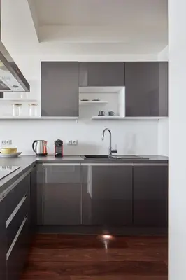a kitchen with gray cabinets and a sink at Prague Days - One-bedroom Apartment with Balcony and Garage Parking near the Vltava River in Holešovice in Prague